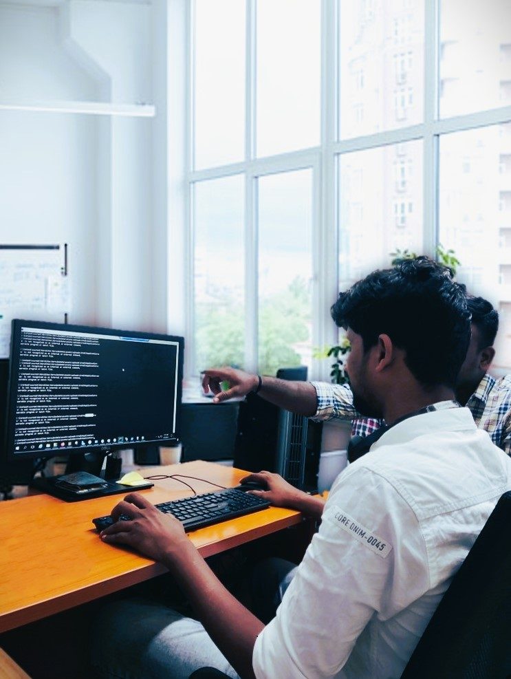 Engineers working across monitors in the office