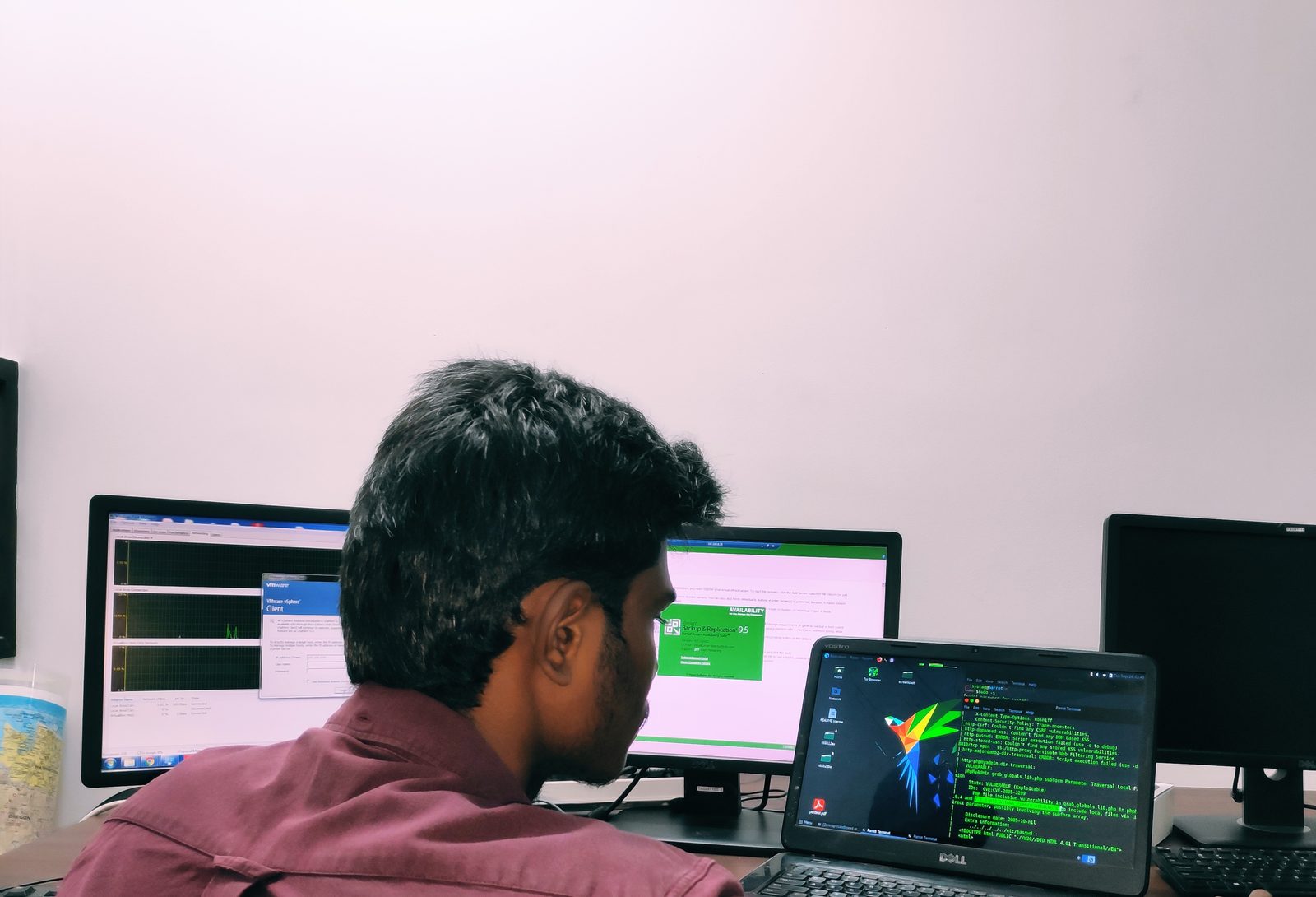 Engineer monitoring open-source SOC tooling across multiple screens